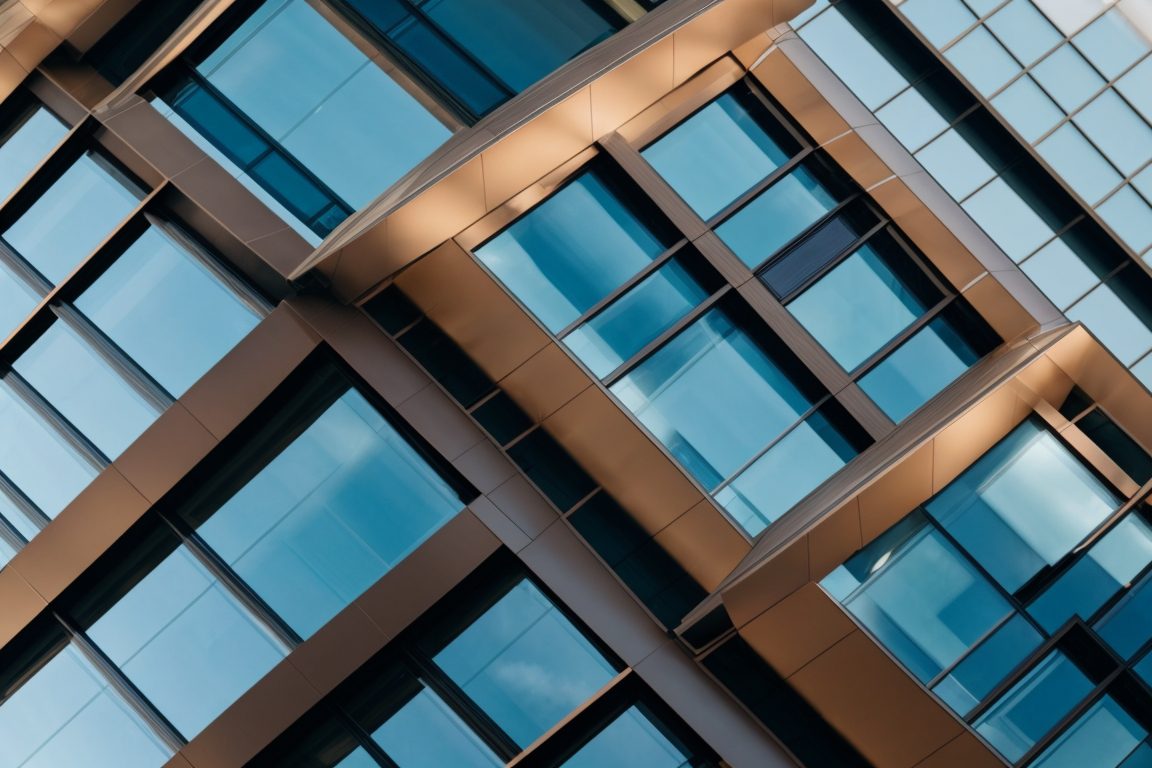 Modern office building in Denver with energy-efficient window film installed, sunny day, sleek architecture